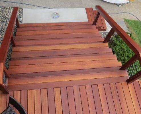 Batu-stairs-and-cable-rail a top view of a batu stairway and stair rail. The deck has been stained with Exoshield deck stain. The railing posts have been drilled for Ultra-tec cable rail fittings