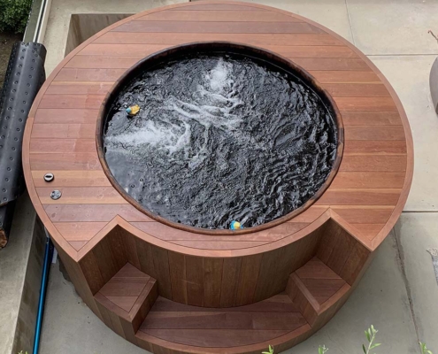 Hot-tub-wrapped-with-South-Pacific-Redwood-Manilkara-Torem-on-patio A top view of a hot tub enclosure built with the South Pacific hardwood Torem