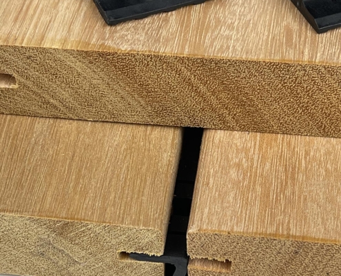 bangkirai-grooved-54x6-clip-use A sample photo of the end grain of grooved yellow balau shows how hidden fastener clips engage with the groove in the board.